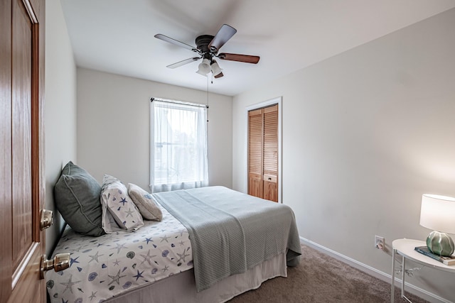 bedroom with a closet, carpet flooring, baseboards, and ceiling fan