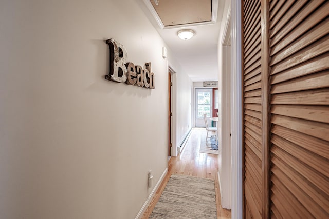 hallway with light wood-style floors and baseboards