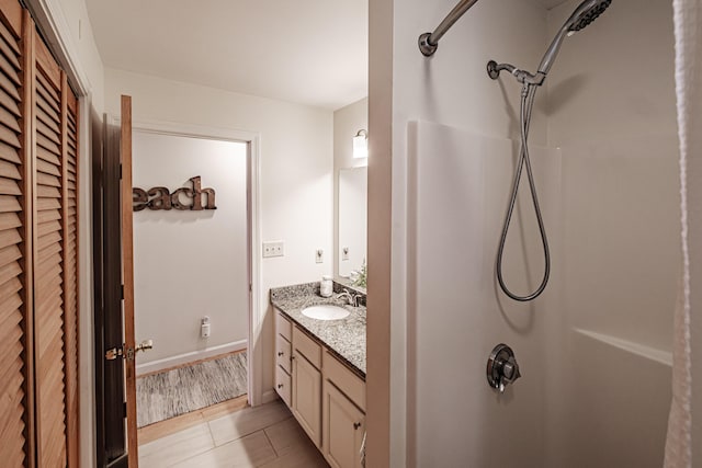 bathroom with vanity, tile patterned floors, and a shower