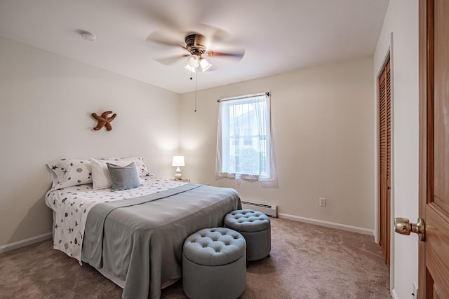 bedroom featuring carpet floors, baseboards, a baseboard heating unit, and a closet