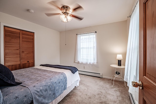 bedroom with light carpet, a ceiling fan, baseboards, a baseboard radiator, and a closet