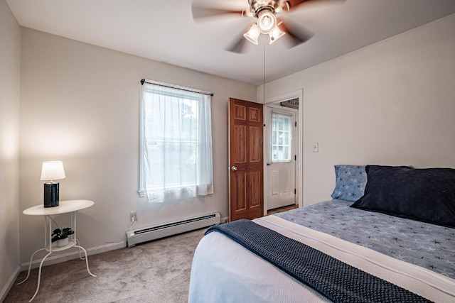 bedroom with a ceiling fan, baseboards, baseboard heating, and carpet
