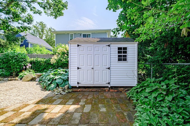 view of shed with fence