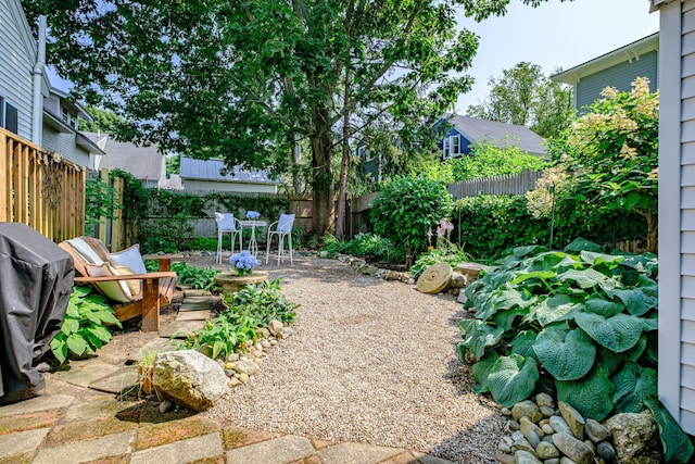 view of yard with a patio, outdoor dining area, and a fenced backyard