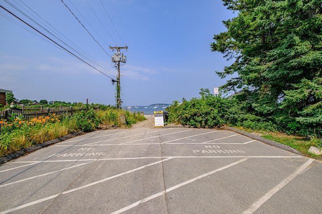 uncovered parking lot featuring fence