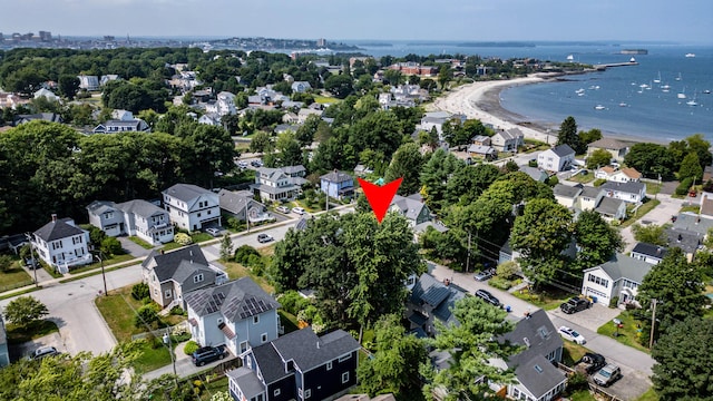 birds eye view of property with a water view, a beach view, and a residential view