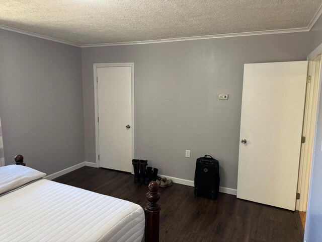 bedroom with baseboards, a closet, ornamental molding, dark wood-style floors, and a textured ceiling