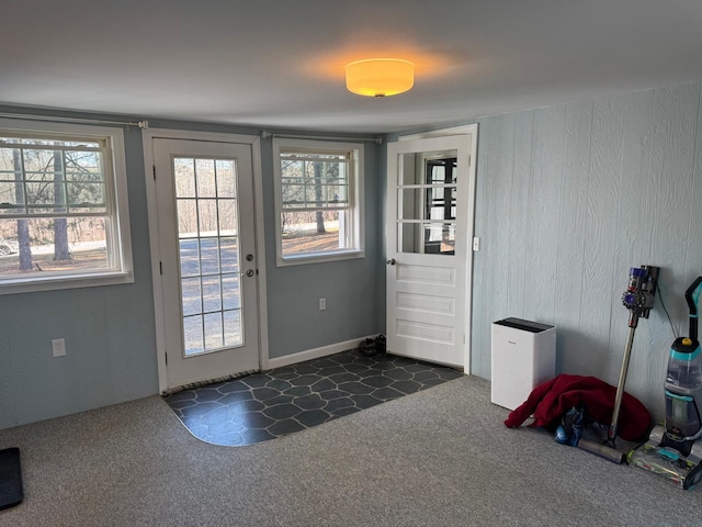 doorway with dark colored carpet