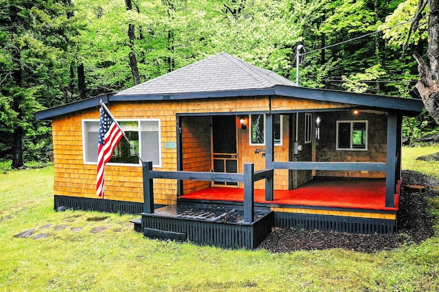 bungalow-style home featuring a wooded view and a front yard