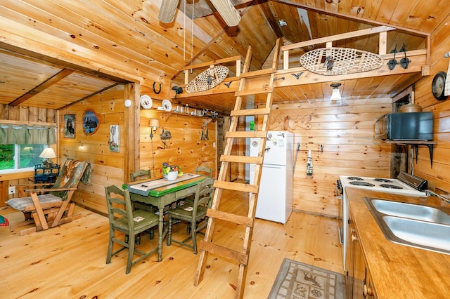 kitchen featuring wood ceiling, butcher block counters, wooden walls, vaulted ceiling with beams, and white appliances