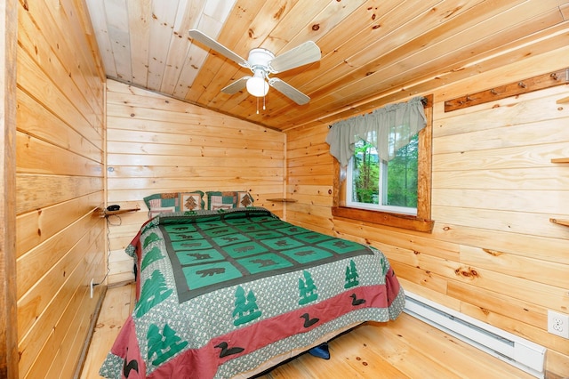 bedroom featuring wooden walls, baseboard heating, wood finished floors, lofted ceiling, and wood ceiling