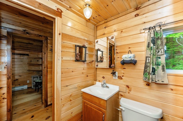 half bath with wood ceiling, wood walls, vanity, wood-type flooring, and toilet