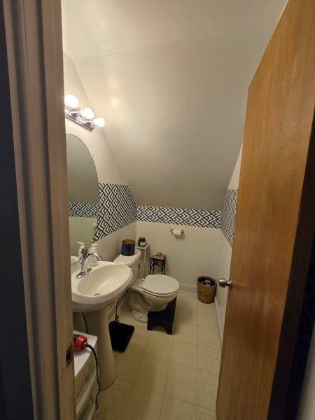 9 Allen Avenue Ext, Falmouth, ME 04105 - bathroom with a sink, vaulted ceiling, toilet, and tile patterned floors
