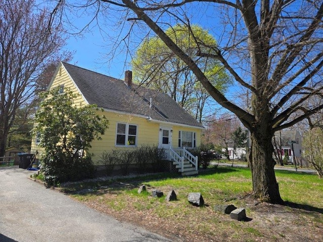 9 Allen Avenue Ext, Falmouth, ME 04105 - view of side of home with roof with shingles, a chimney, and a lawn