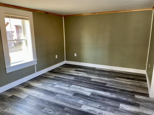 unfurnished room featuring dark wood finished floors and baseboards