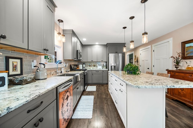 35 Graystone Dr, Hampden, ME 04444 - kitchen featuring dark wood-style flooring, light stone countertops, gray cabinets, a sink, and appliances with stainless steel finishes