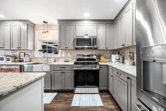 35 Graystone Dr, Hampden, ME 04444 - kitchen featuring a sink, appliances with stainless steel finishes, backsplash, and gray cabinetry