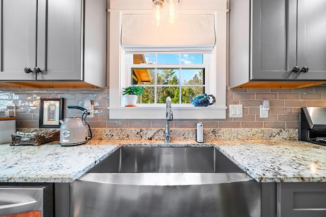 35 Graystone Dr, Hampden, ME 04444 - kitchen with light stone counters, a sink, and gray cabinetry