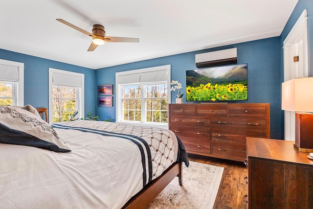 35 Graystone Dr, Hampden, ME 04444 - bedroom with ceiling fan, a wall unit AC, and wood finished floors