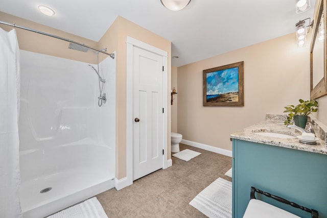 35 Graystone Dr, Hampden, ME 04444 - bathroom with vanity, toilet, baseboards, and a shower