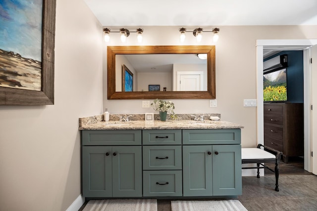 35 Graystone Dr, Hampden, ME 04444 - bathroom with double vanity, baseboards, a sink, and wood finished floors
