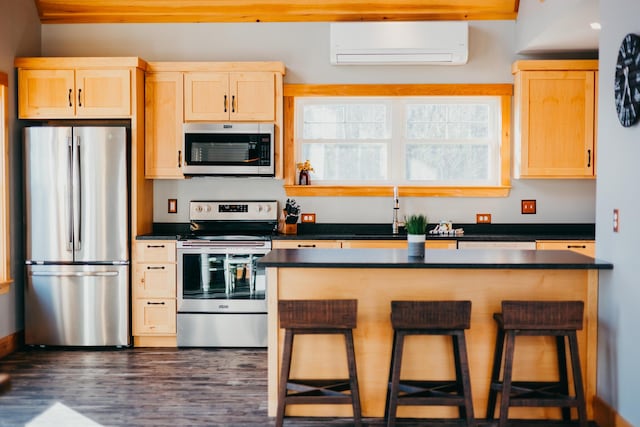 104 Hamlin Rd, Waterford, ME 04088 - kitchen featuring stainless steel appliances, dark countertops, a wall unit AC, and light brown cabinets