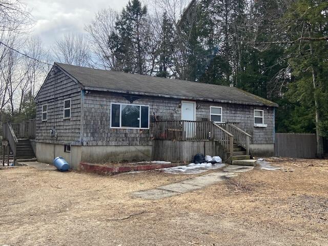 ranch-style house with roof with shingles