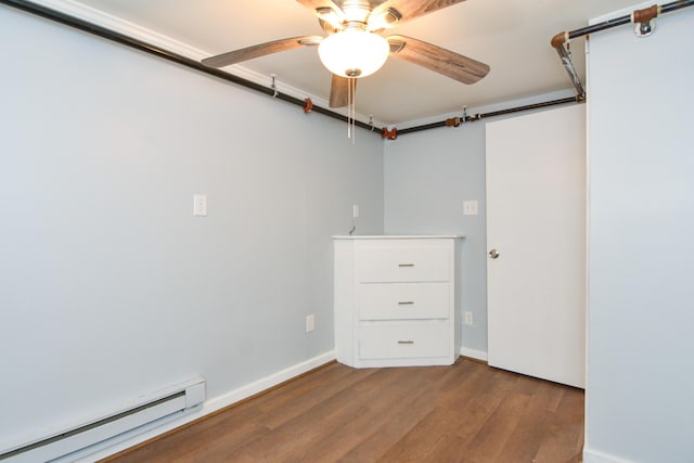 7 Bay Ave Unit 2, Old Orchard Beach, ME 04064 - below grade area featuring a baseboard heating unit, wood finished floors, ceiling fan, and baseboards