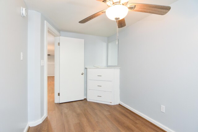 7 Bay Ave Unit 2, Old Orchard Beach, ME 04064 - unfurnished bedroom featuring wood finished floors, baseboards, and a ceiling fan