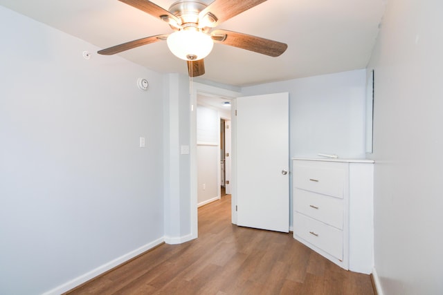 7 Bay Ave Unit 2, Old Orchard Beach, ME 04064 - unfurnished bedroom with wood finished floors, baseboards, and a ceiling fan