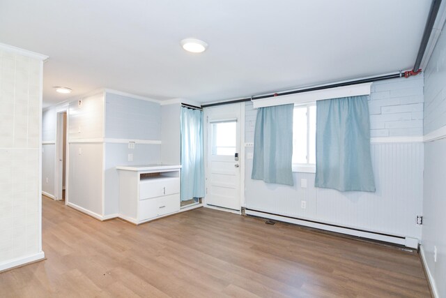 7 Bay Ave Unit 2, Old Orchard Beach, ME 04064 - unfurnished room with a baseboard heating unit, wood finished floors, and baseboards