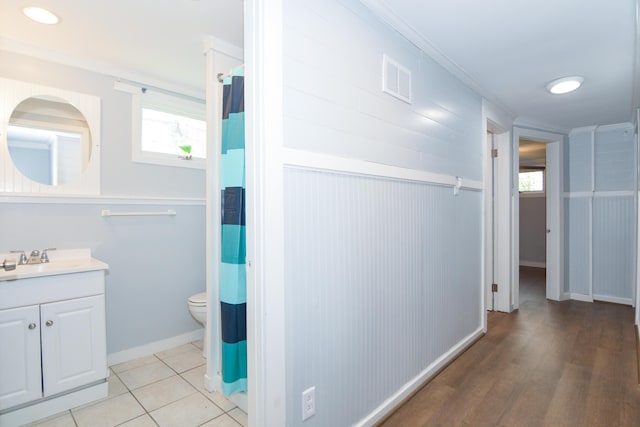 7 Bay Ave Unit 2, Old Orchard Beach, ME 04064 - full bath with plenty of natural light, toilet, vanity, crown molding, and wood finished floors