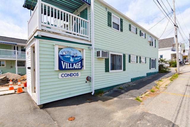 7 Bay Ave Unit 2, Old Orchard Beach, ME 04064 - view of home's exterior with an AC wall unit and a balcony