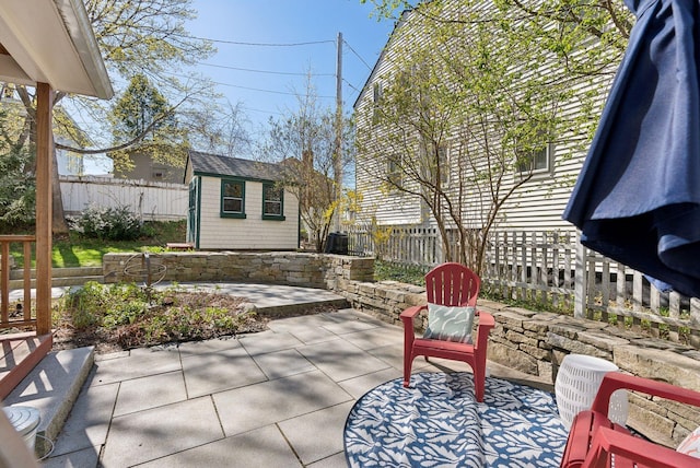 11 Linden St, Bath, ME 04530 - view of patio / terrace with an outdoor structure, a storage shed, and a fenced backyard