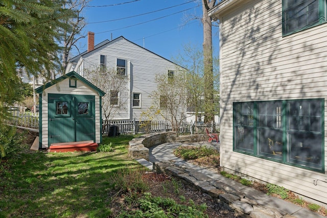 11 Linden St, Bath, ME 04530 - view of side of property featuring central AC, a storage unit, a chimney, fence, and an outdoor structure