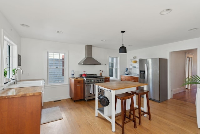 11 Linden St, Bath, ME 04530 - kitchen featuring wall chimney range hood, stainless steel appliances, butcher block countertops, and open shelves