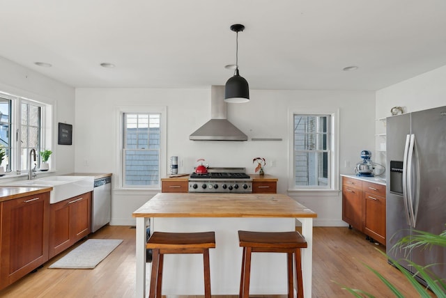 11 Linden St, Bath, ME 04530 - kitchen featuring a sink, stainless steel appliances, wood counters, wall chimney exhaust hood, and light wood-style flooring