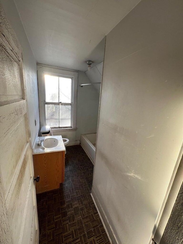 full bath featuring vanity, baseboards, walk in shower, and toilet
