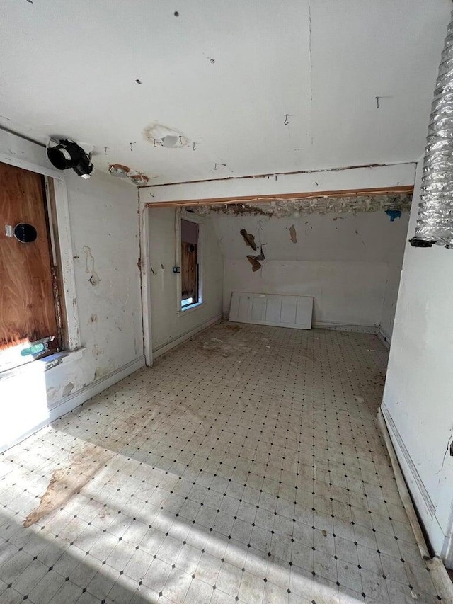 interior space with tile patterned floors and baseboards