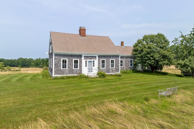 651 N Shore Rd, North Haven, ME 04853 - rear view of house featuring a chimney, a yard, and roof with shingles
