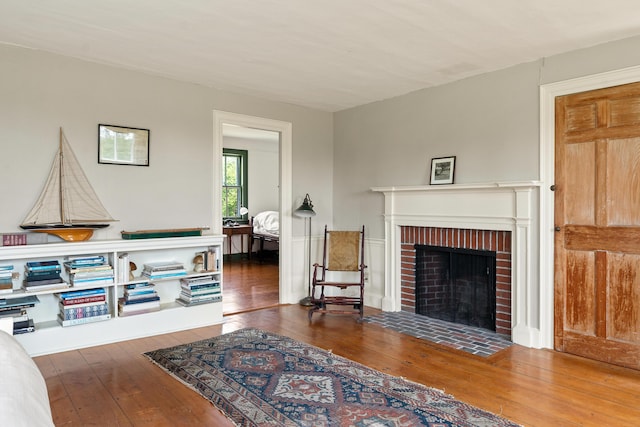 651 N Shore Rd, North Haven, ME 04853 - living room featuring a brick fireplace and hardwood / wood-style flooring