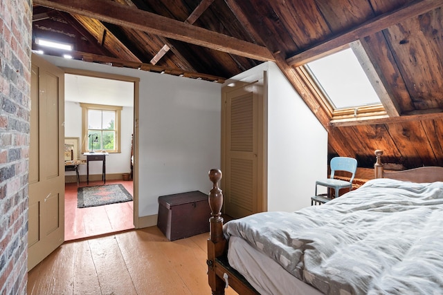 651 N Shore Rd, North Haven, ME 04853 - bedroom with a skylight, light wood-type flooring, and wood ceiling