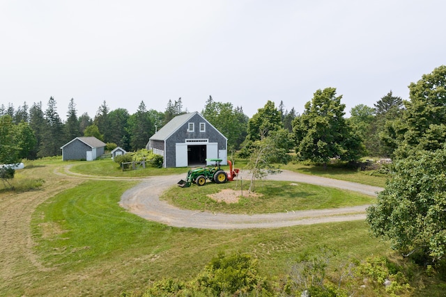 651 N Shore Rd, North Haven, ME 04853 - view of green lawn with a garage, dirt driveway, and an outdoor structure
