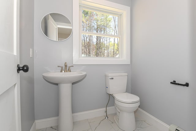 32 Rockwood Dr, Harrison, ME 04040 - half bathroom featuring marble finish floor, toilet, baseboards, a baseboard heating unit, and a sink