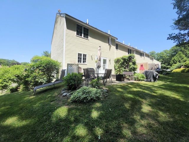 56 Hydrangea Cir Unit 10, Naples, ME 04055 - back of house with a patio and a lawn