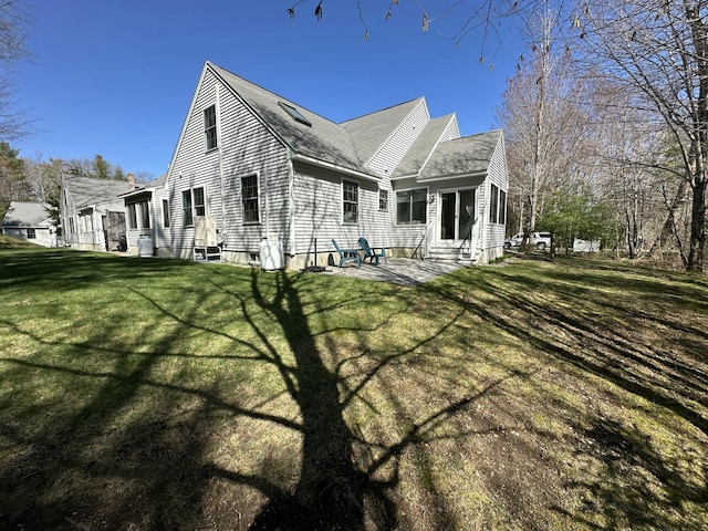 rear view of house with a lawn, a shingled roof, a patio, and entry steps