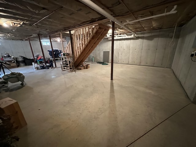 unfinished below grade area featuring stairs
