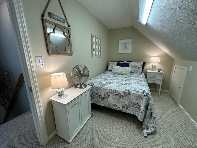 bedroom with baseboards, a textured ceiling, lofted ceiling, and light carpet