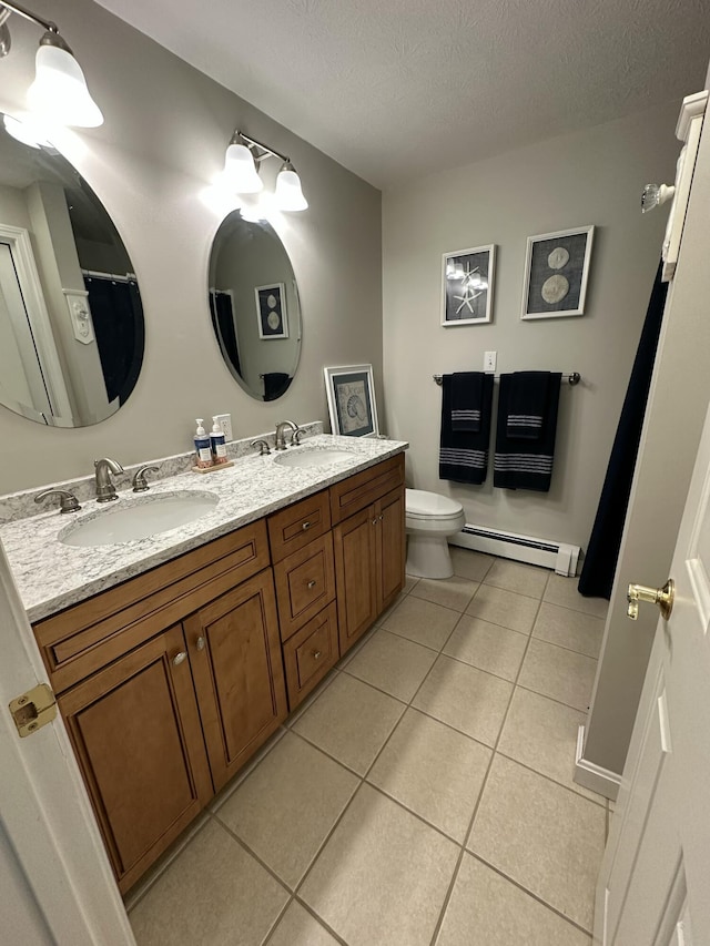 full bathroom with baseboard heating, a textured ceiling, a sink, and tile patterned flooring