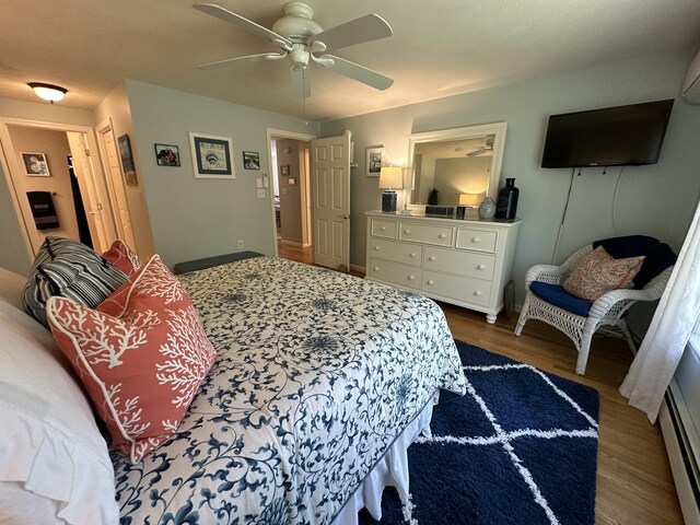 bedroom featuring baseboards, a ceiling fan, and wood finished floors